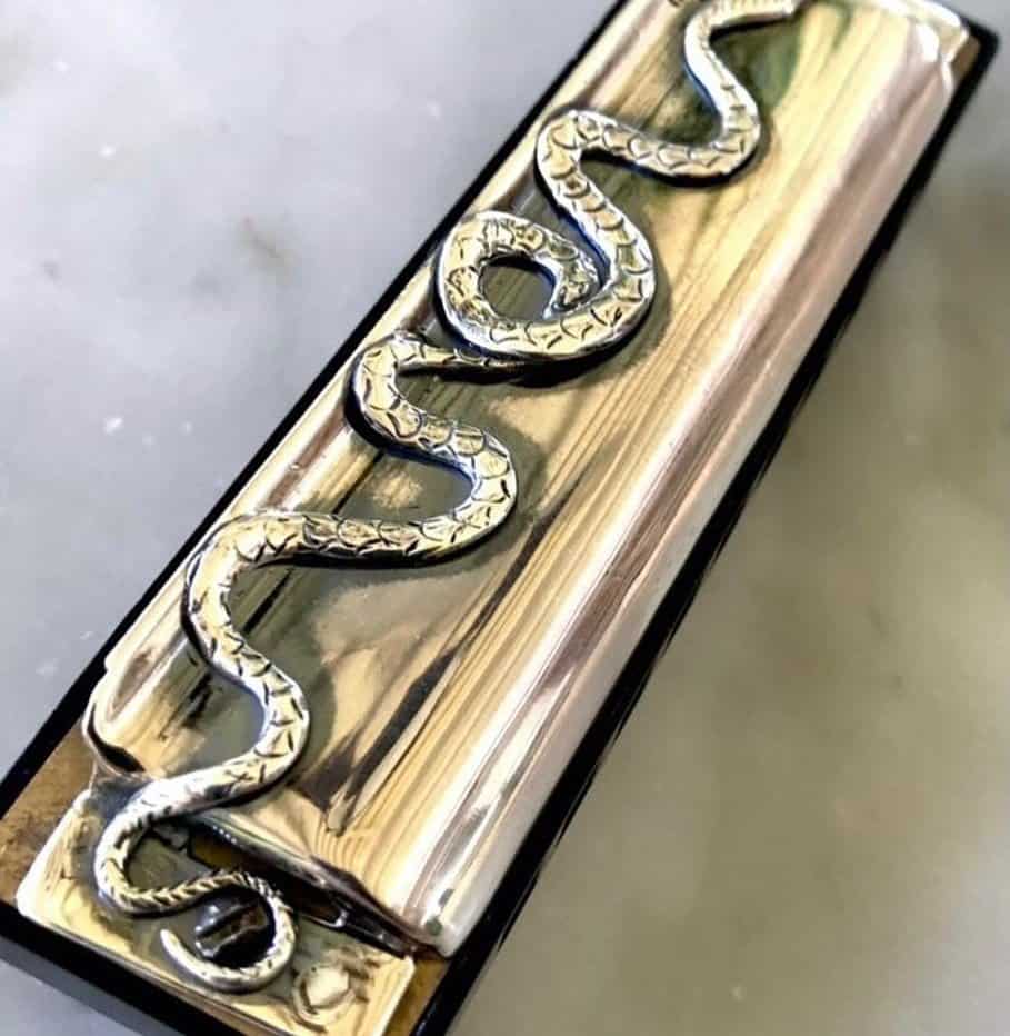 harmonica with snake engraving