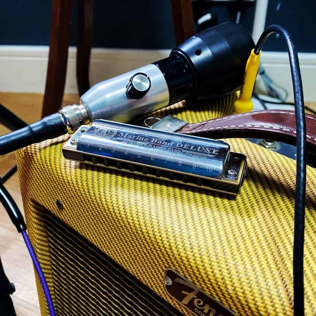 harmonica on a yellow amplifier